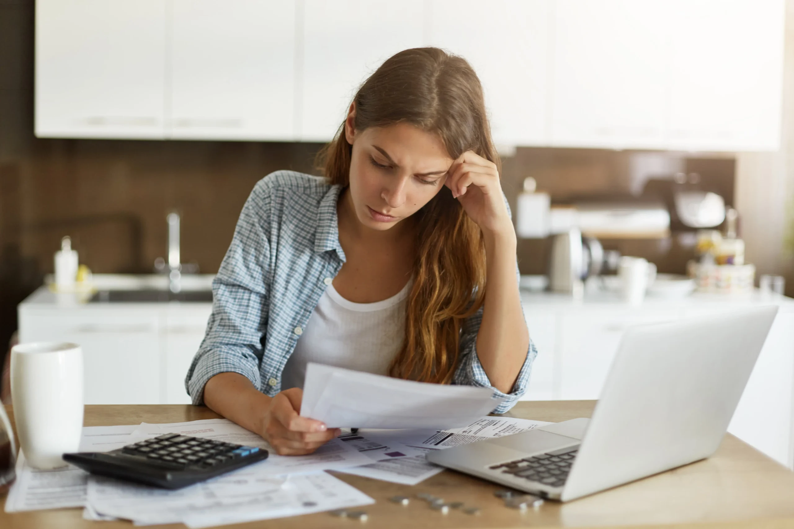 Woman calculating how much money she could save by installing solar panels