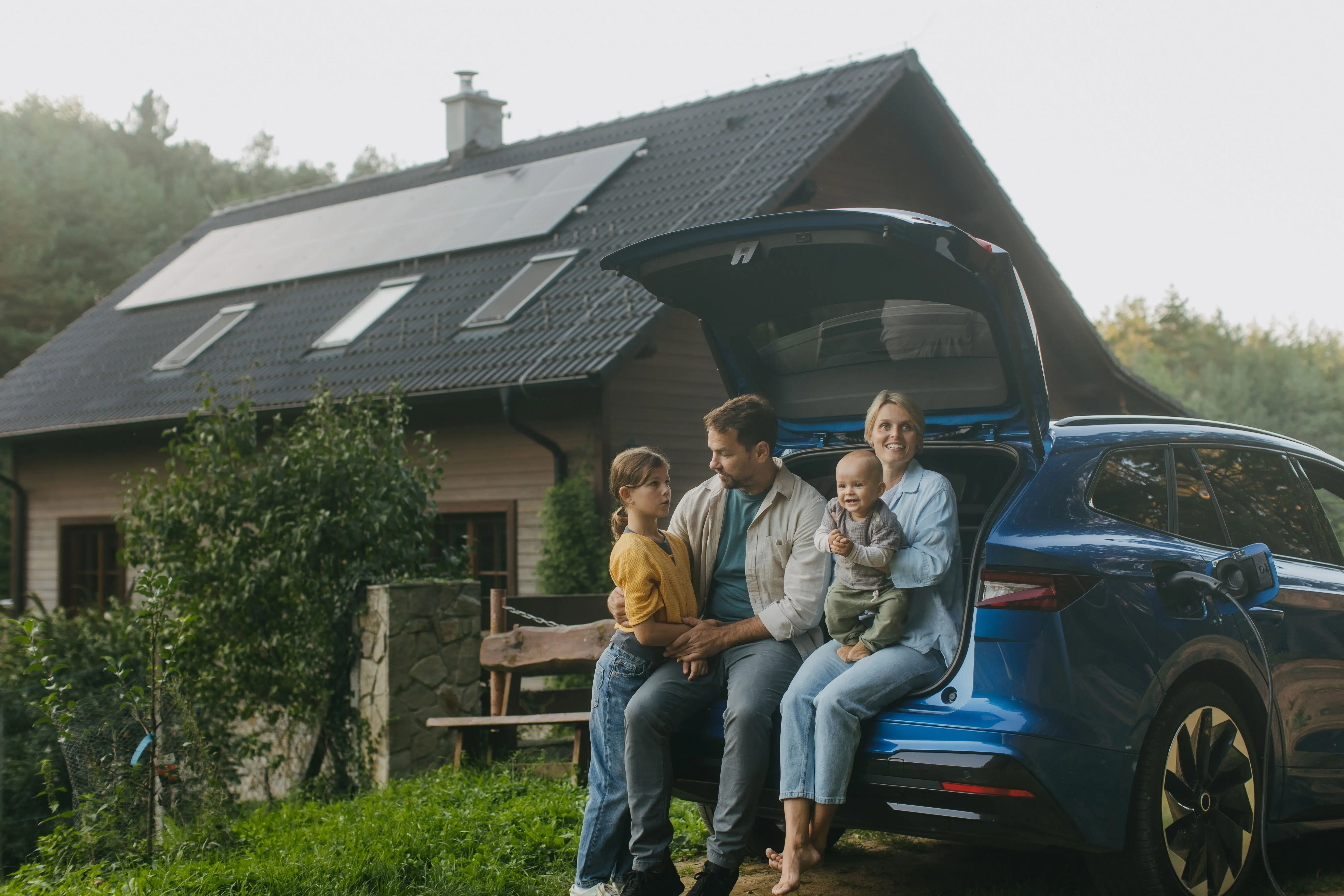 A family happy with their electric charger installation at home.