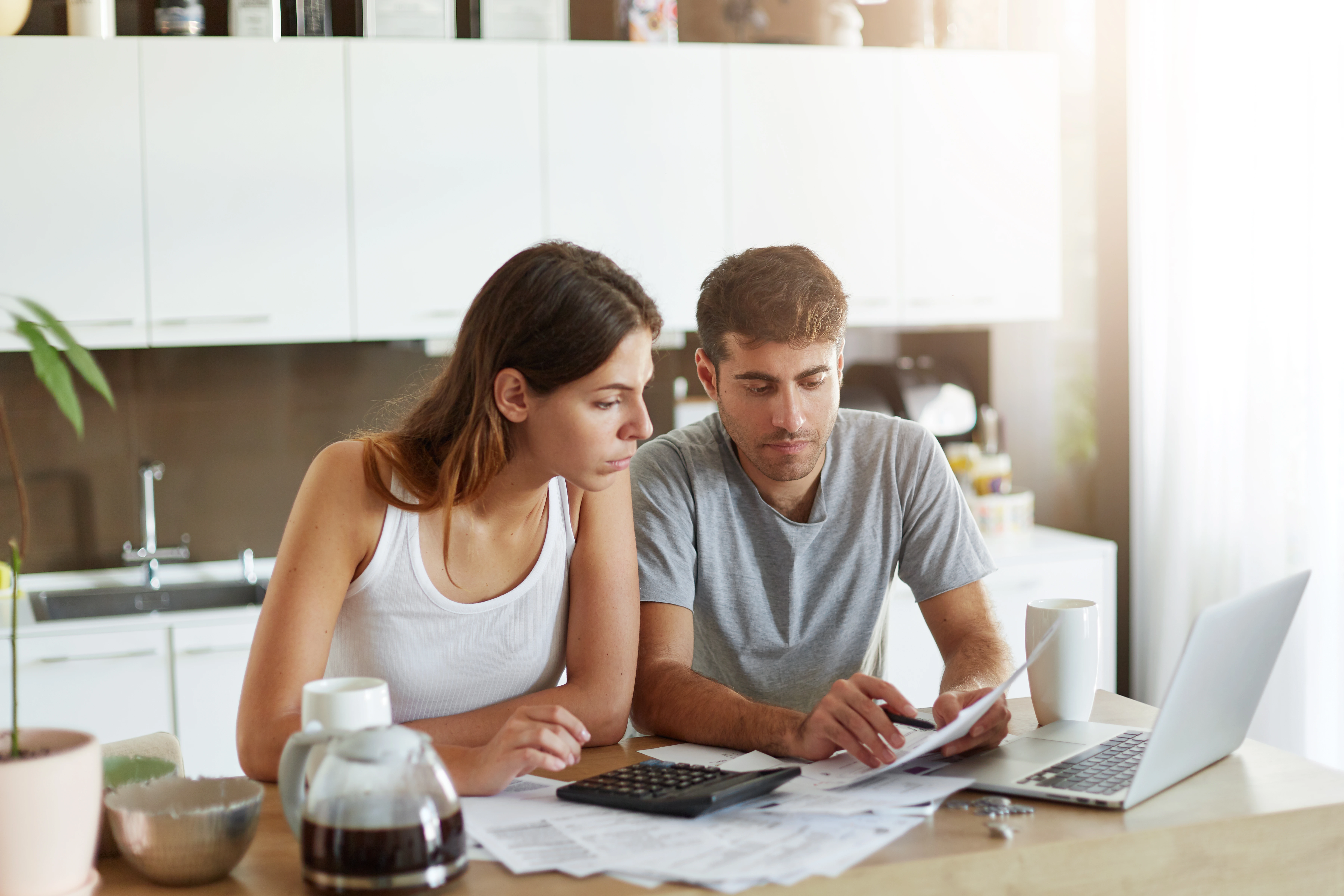 Couple calculating the cost of residential solar panel installation in Bedfordshire