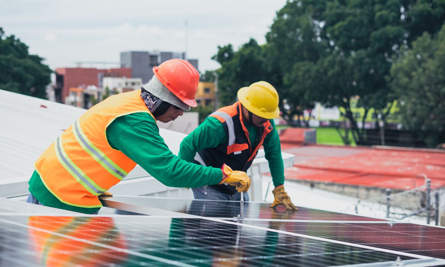 Two people cleaning and maintaining solar panels