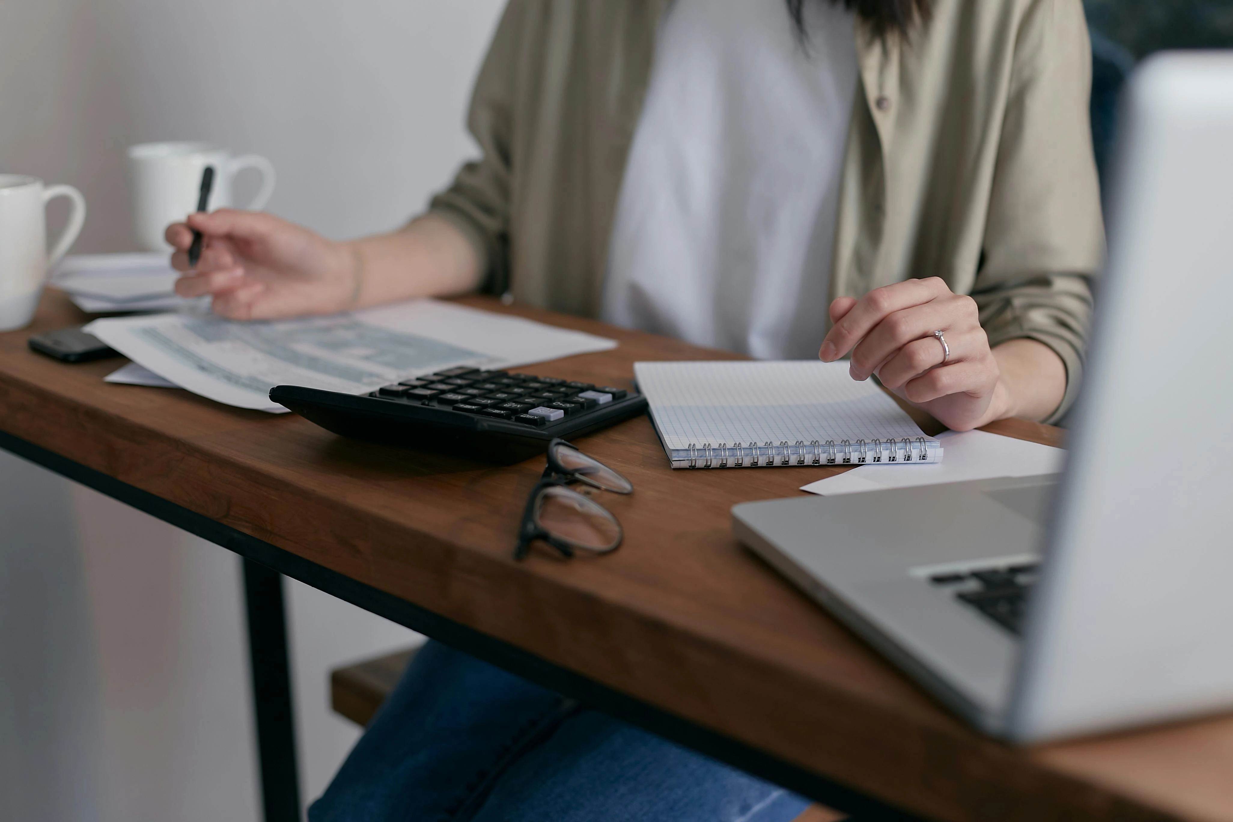 Woman calculating her return on investment for solar panel installation on her home.