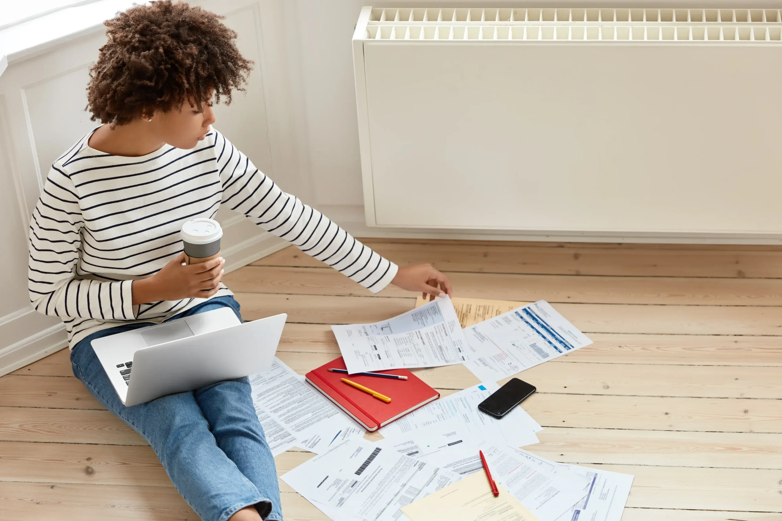 Lady reviewing household energy bills and exploring solar panel grant and help for her home.
