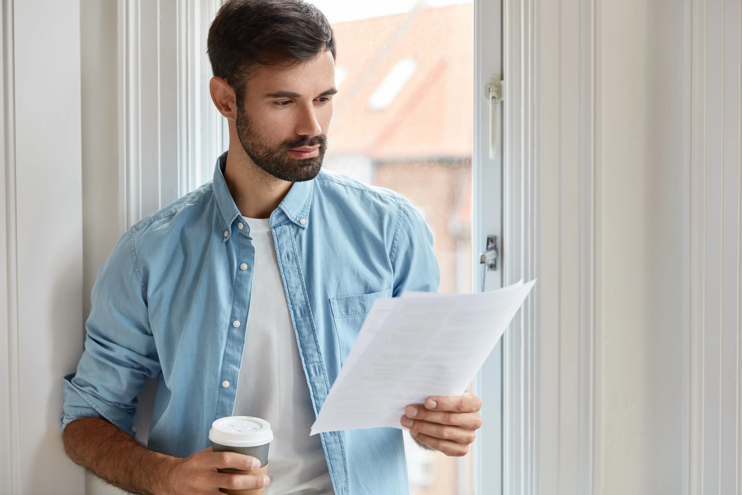 Man reading his solar panel warranty paperwork to see what it includes.