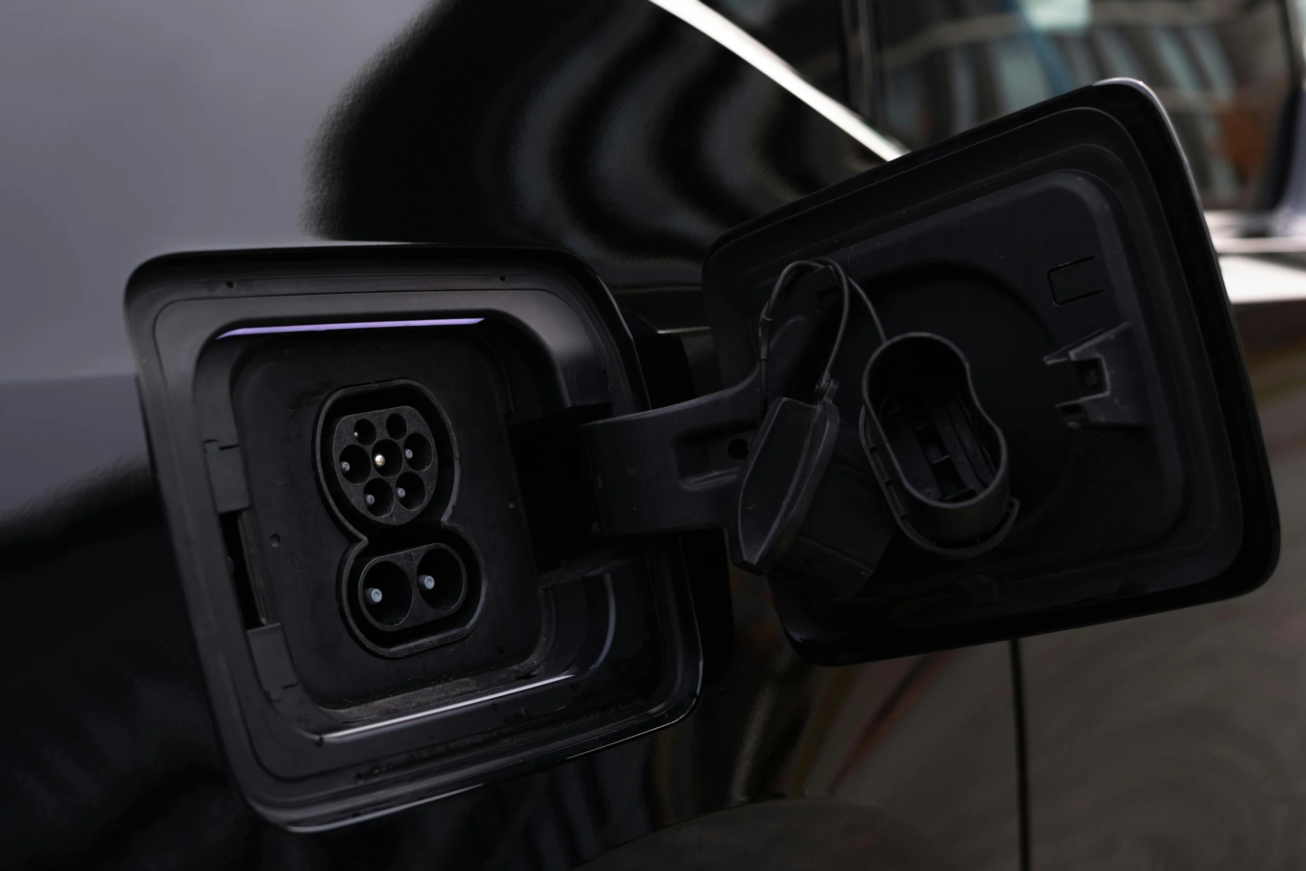 Close-up of an electric vehicle charging port, highlighting the need for specialist training and qualifications to install EV chargers in the UK.