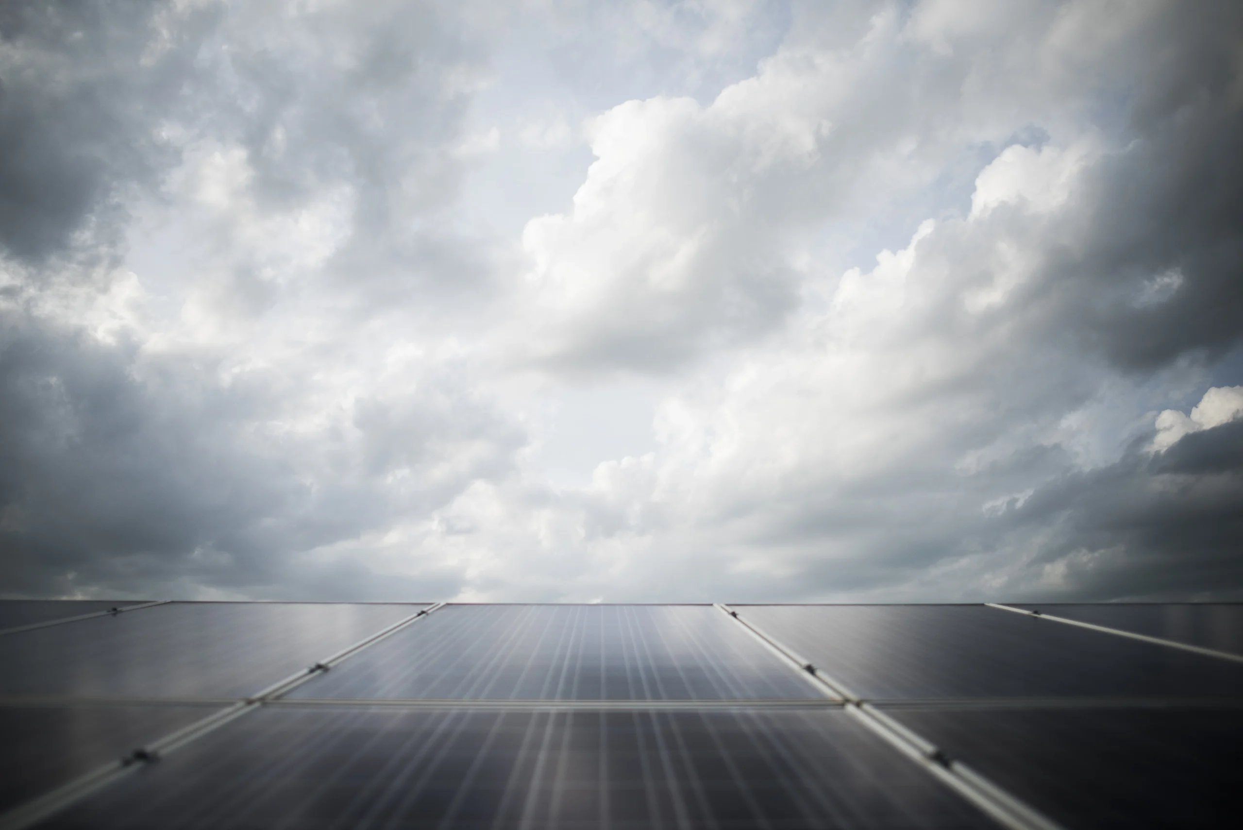 Solar panels in Berkshire under cloudy skies, highlighting how local weather conditions impact solar energy performance.