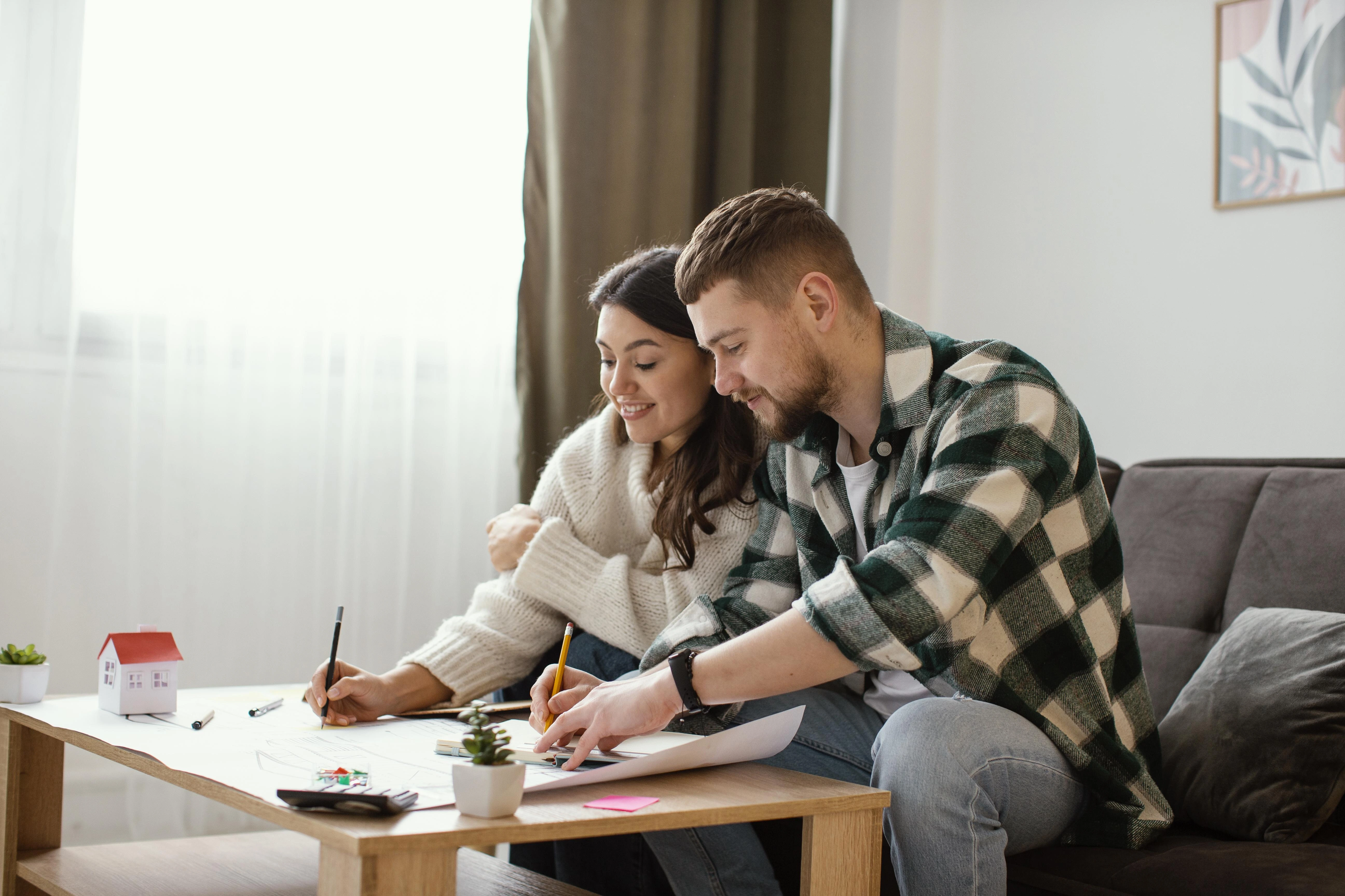 Couple calculating how much money they can earn selling electricity back to the grid