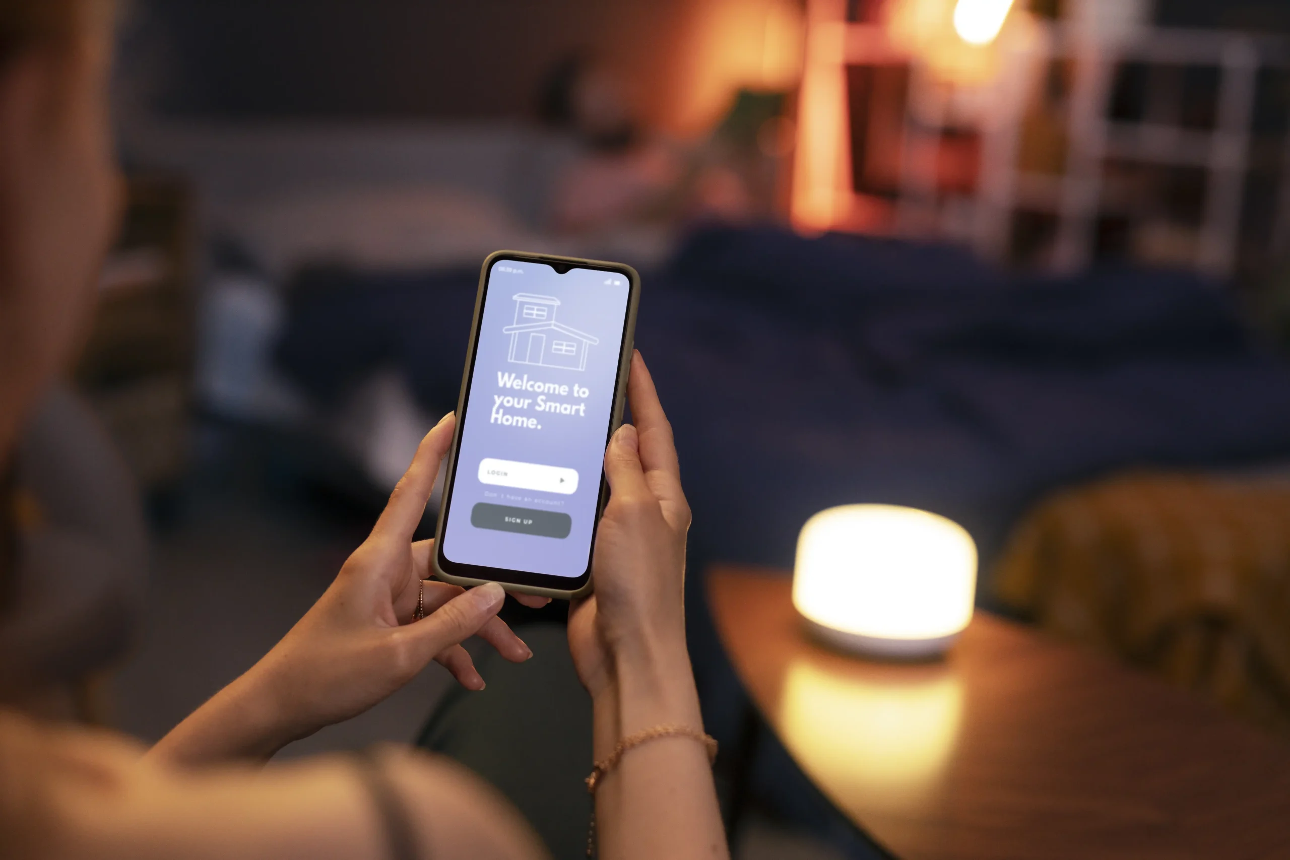 A person using a smart-home app on their phone, representing how a HEMS connects and controls systems like solar panels and home batteries.