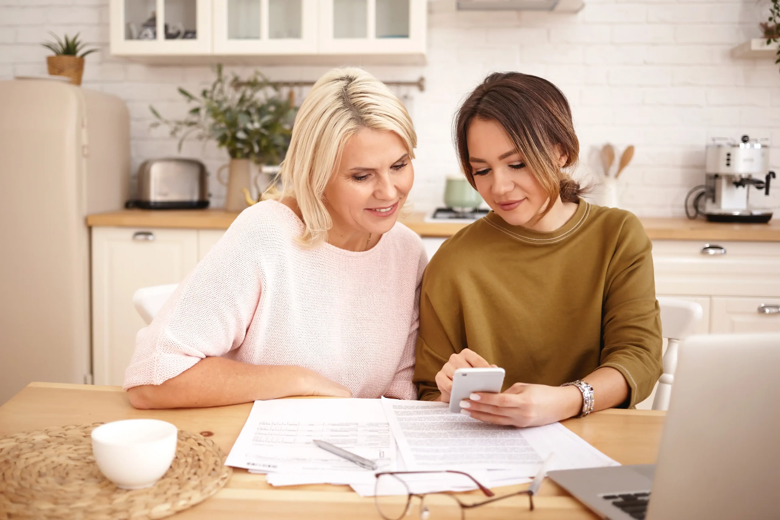 Mother and daughter researching if a home energy management system can lower their solar payback period.