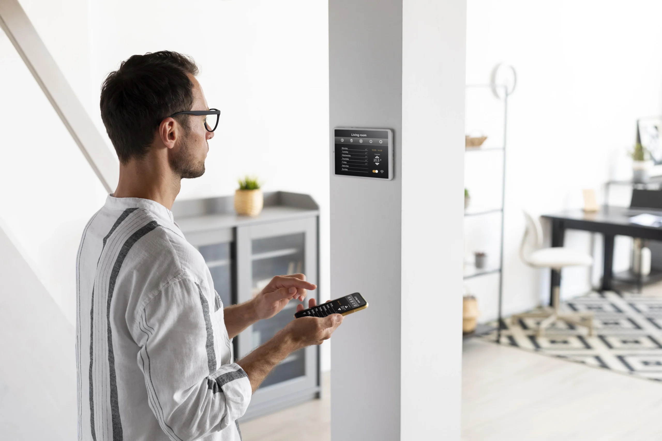 Person checking a smart meter display with a phone, showing how UK households can use smart data to lower energy costs.