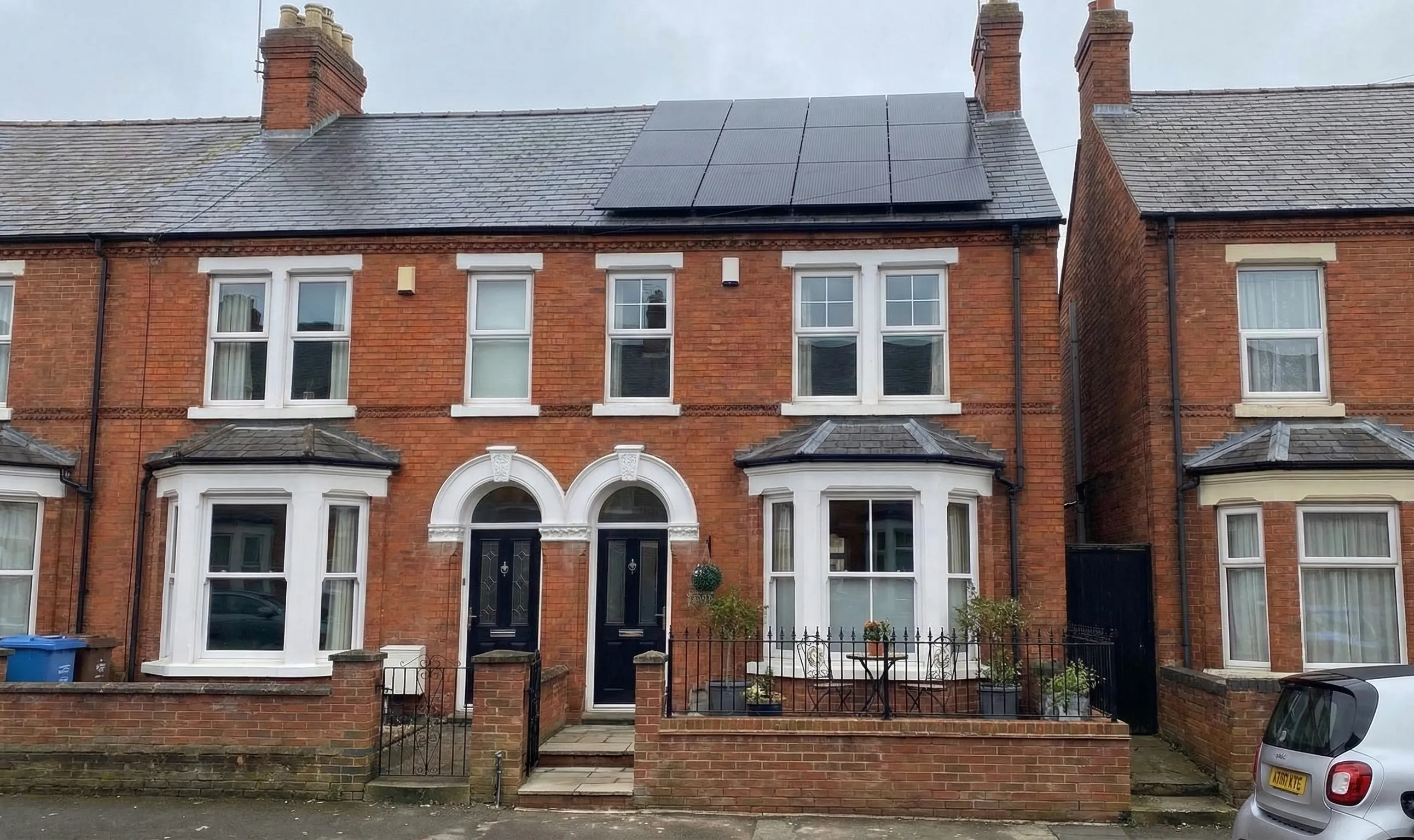 UK terraced houses with rooftop solar panels installed, illustrating how typical row homes can support residential solar systems despite limited roof space.