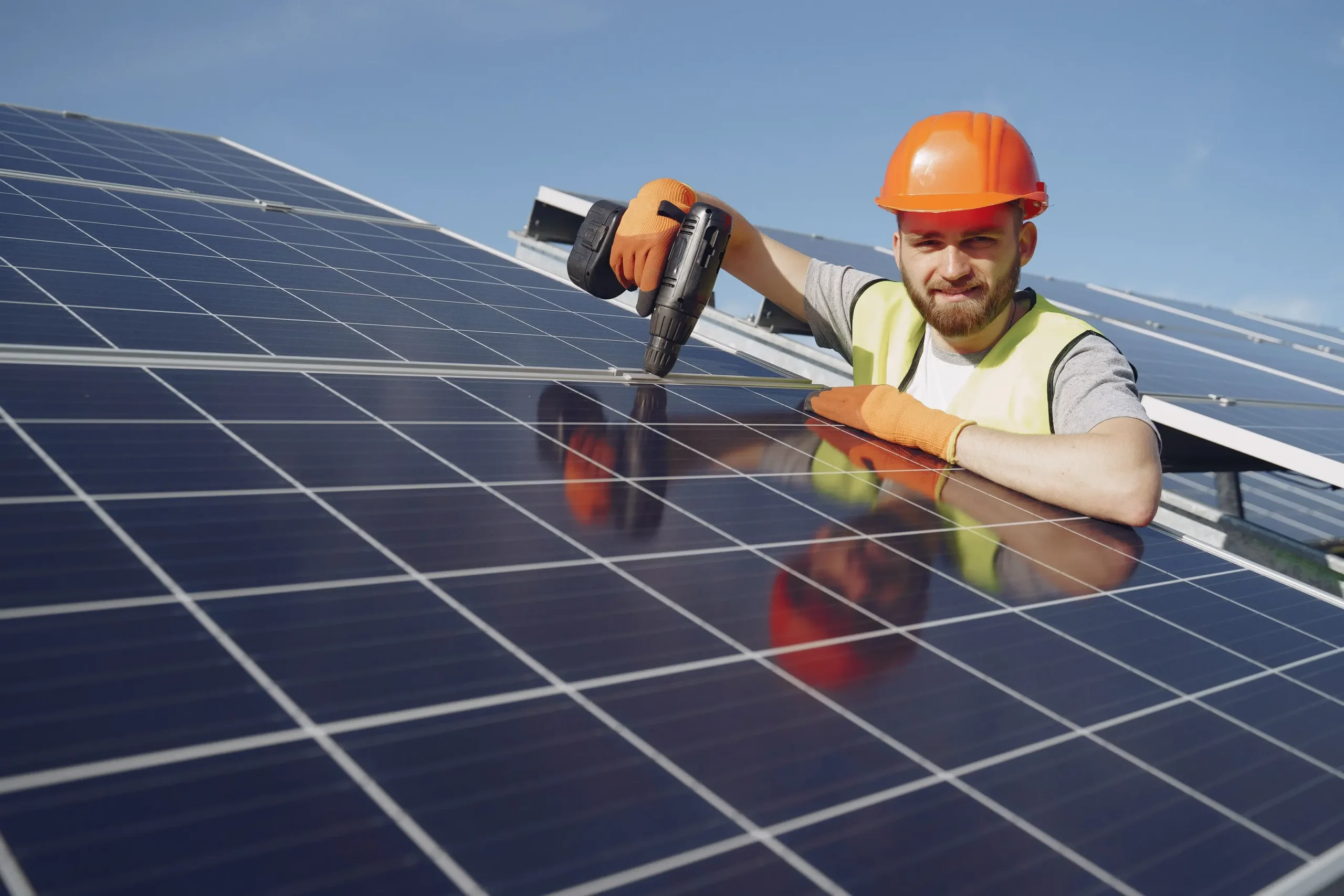 Solar technician removing or servicing rooftop solar panels, illustrating panel removal for roof repairs and safe system reinstallation.