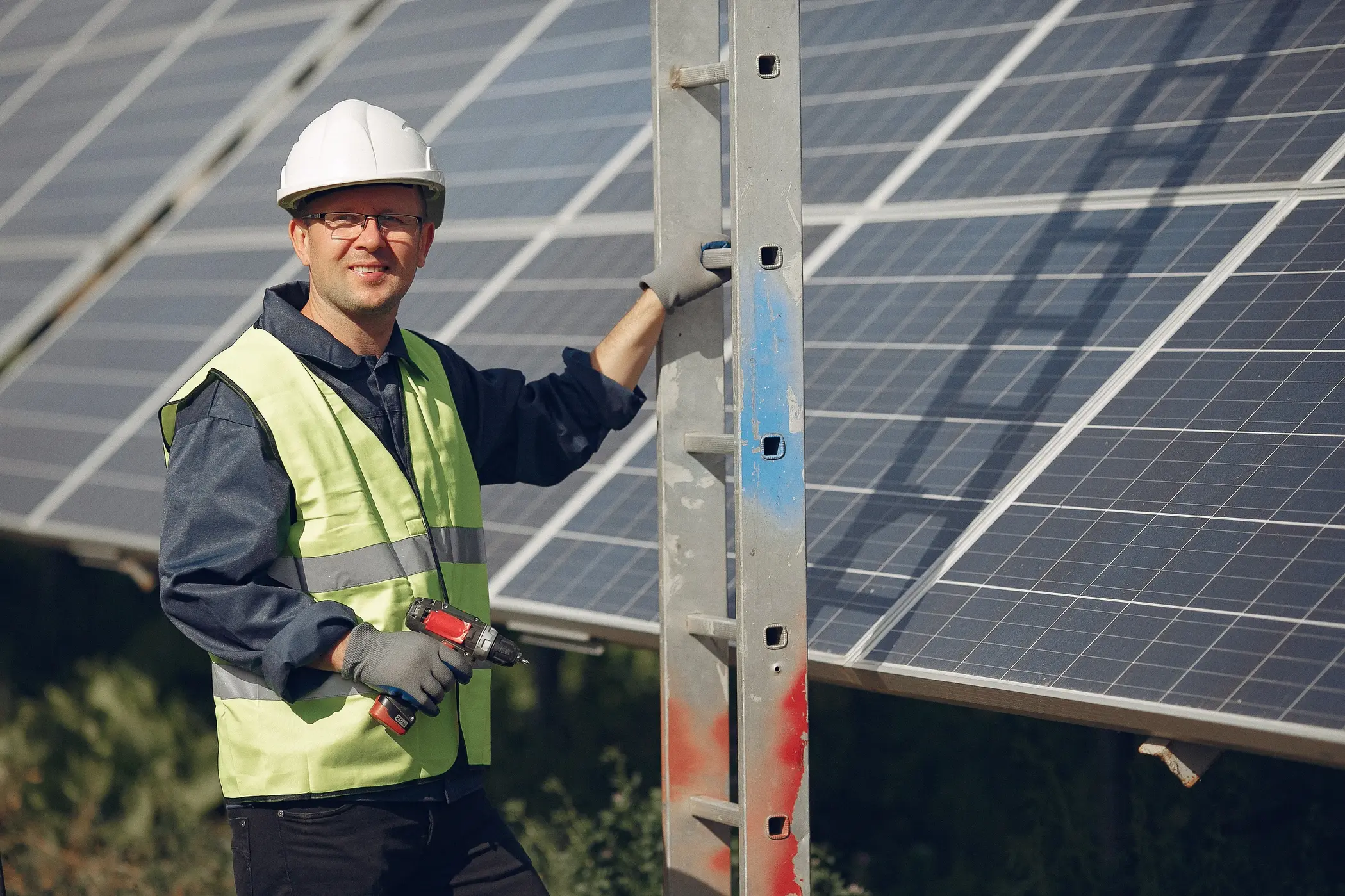 Solar technician inspecting a solar panel system, illustrating when upgrades or component improvements can boost performance and savings.