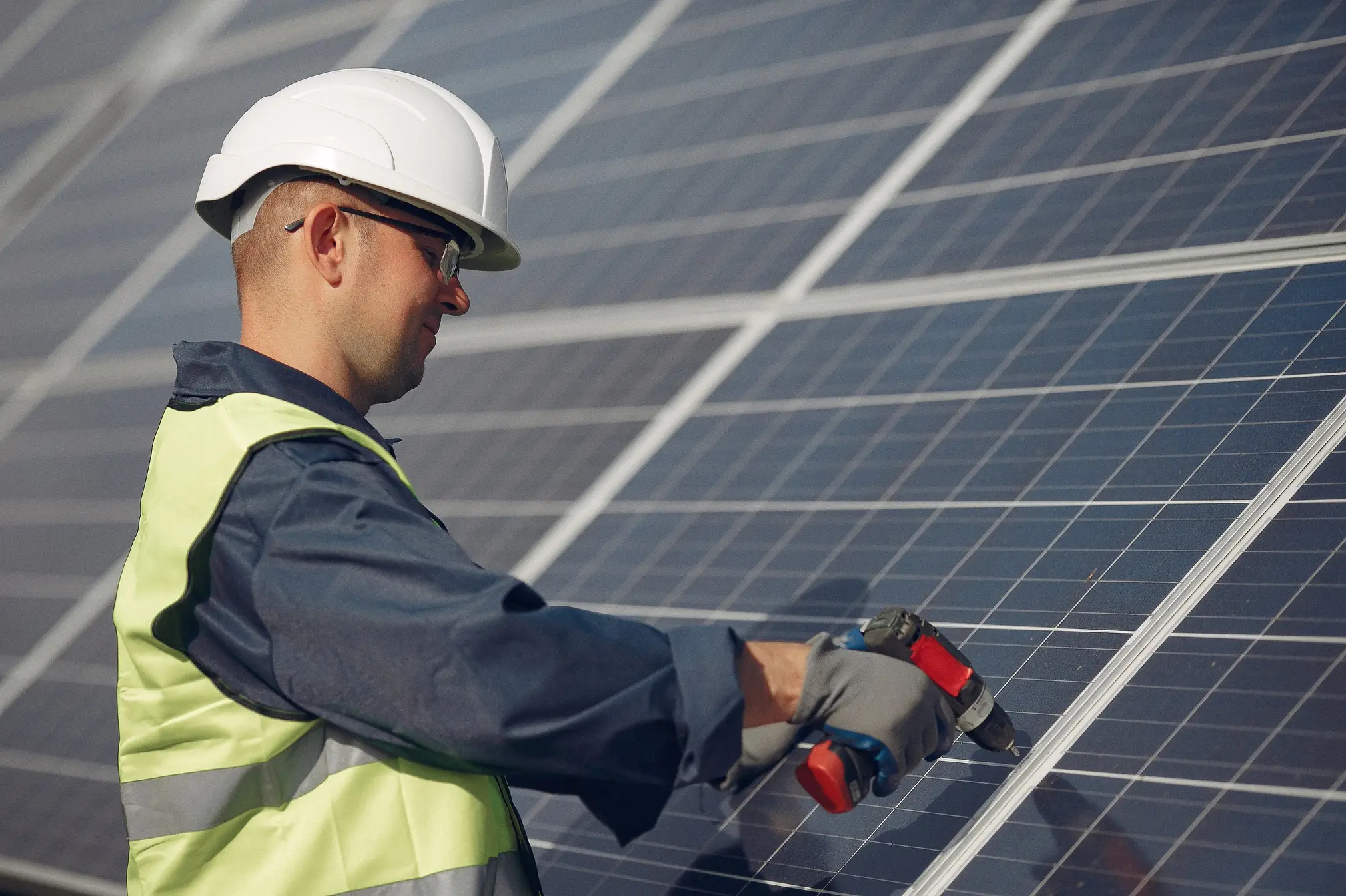 Technician installing or replacing a solar panel on a rooftop system, illustrating maintenance and upgrade of solar installations.