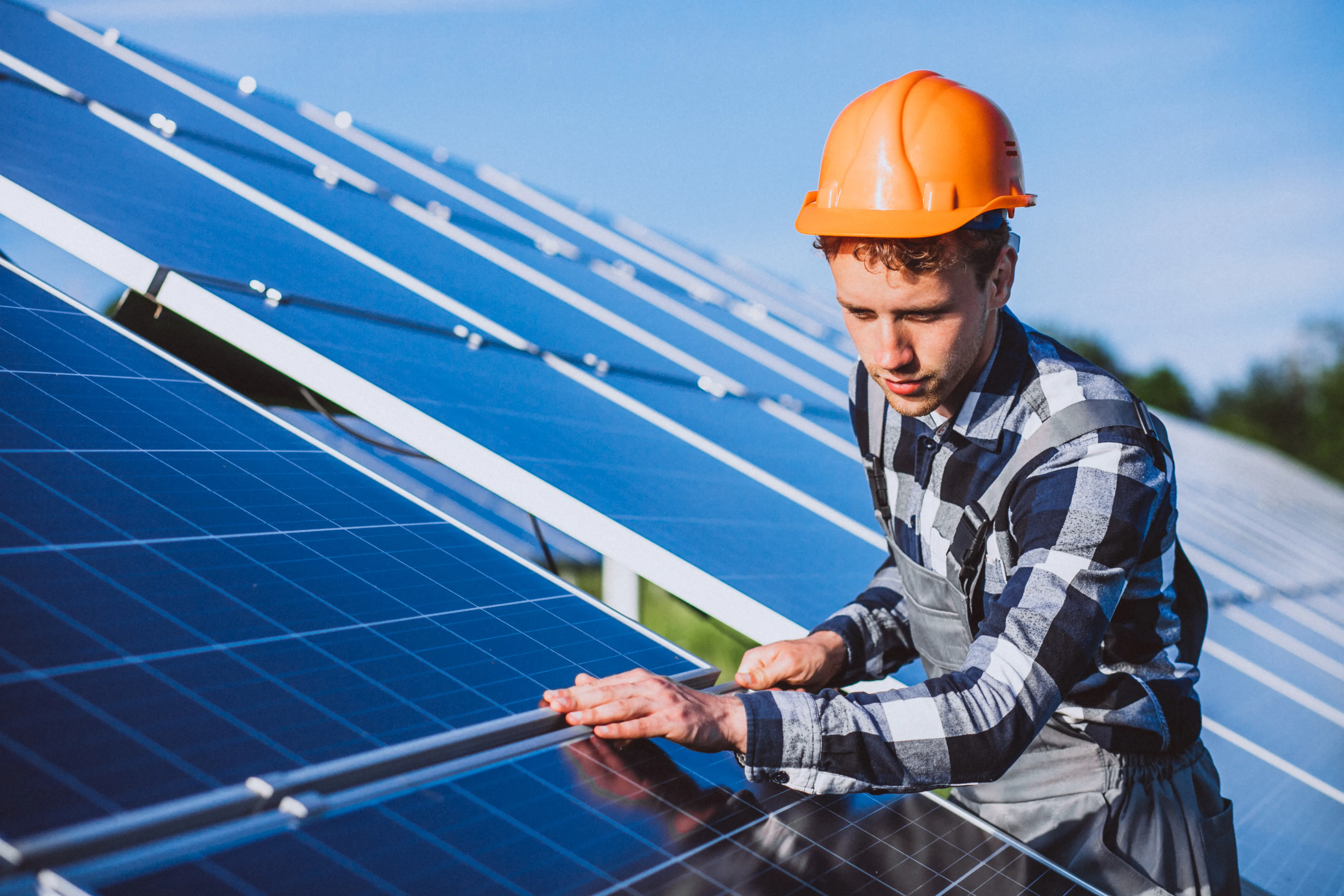 Technician inspecting and expanding an existing solar panel system to improve energy generation and long-term performance.