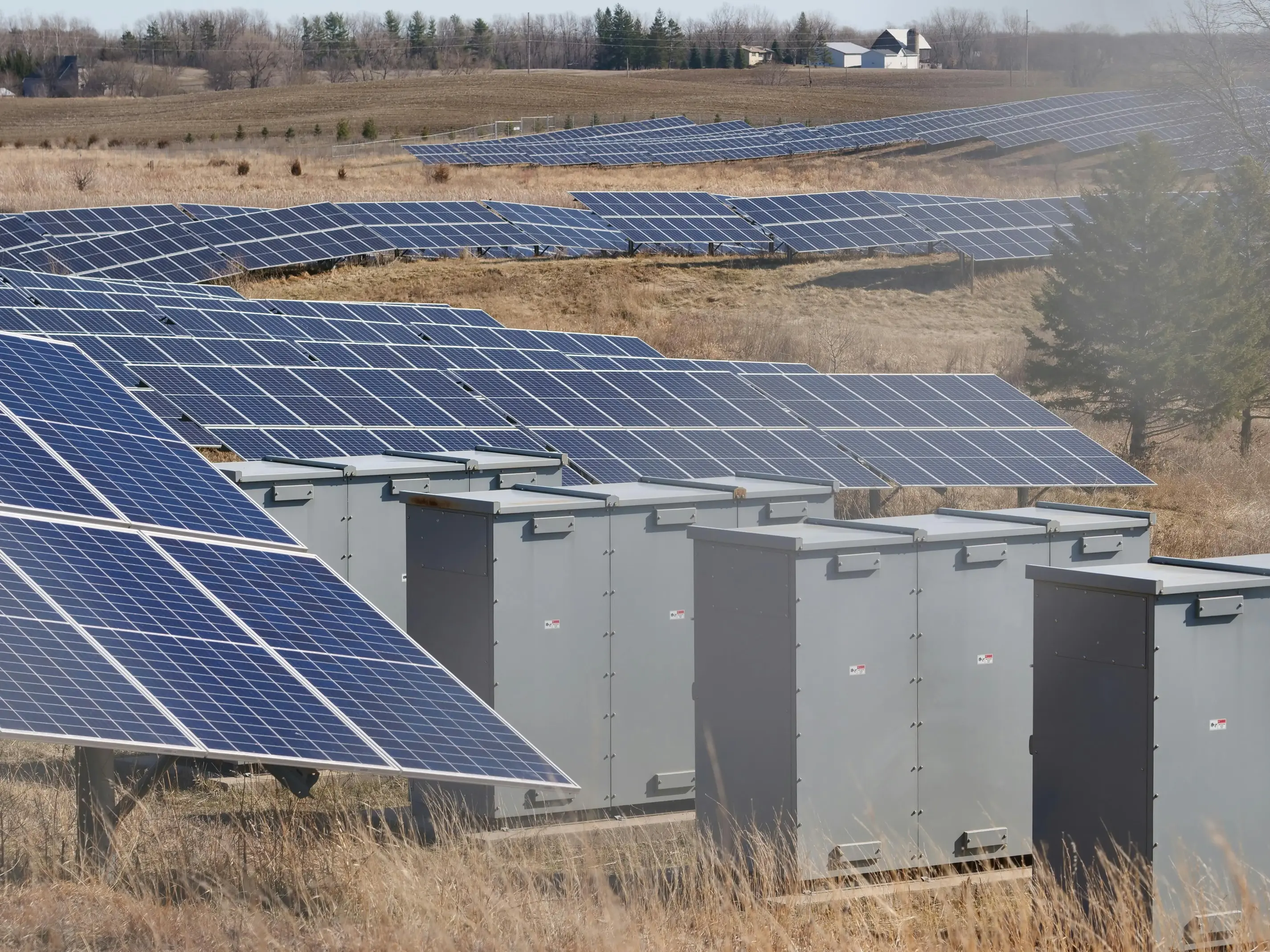 Large-scale solar installation with battery storage units, illustrating how solar capacity is influenced by grid export limits, inverter sizing, and available infrastructure in the UK.