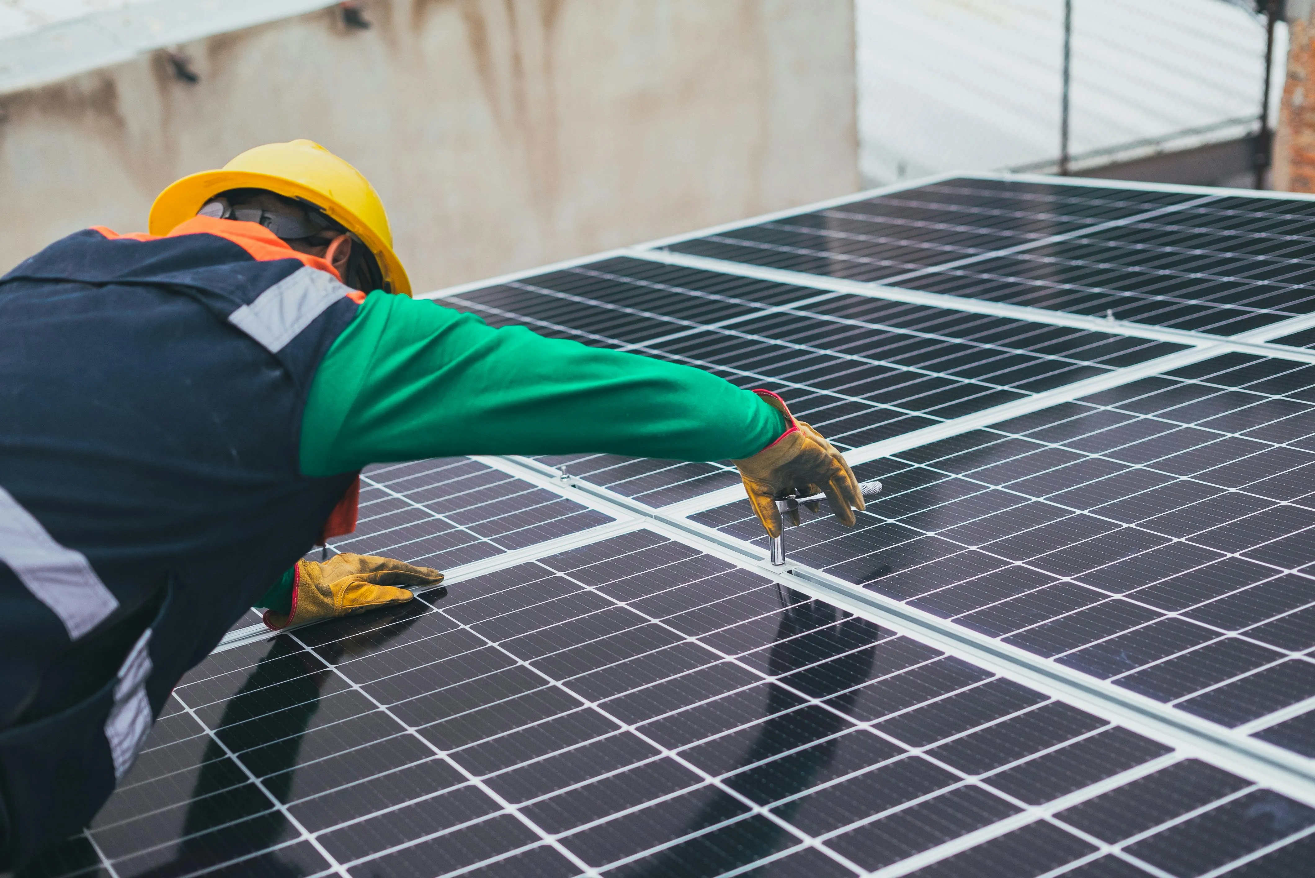 Technician inspecting and testing rooftop solar panels during maintenance, representing the process of troubleshooting solar panel faults, identifying performance issues, and restoring system efficiency safely.