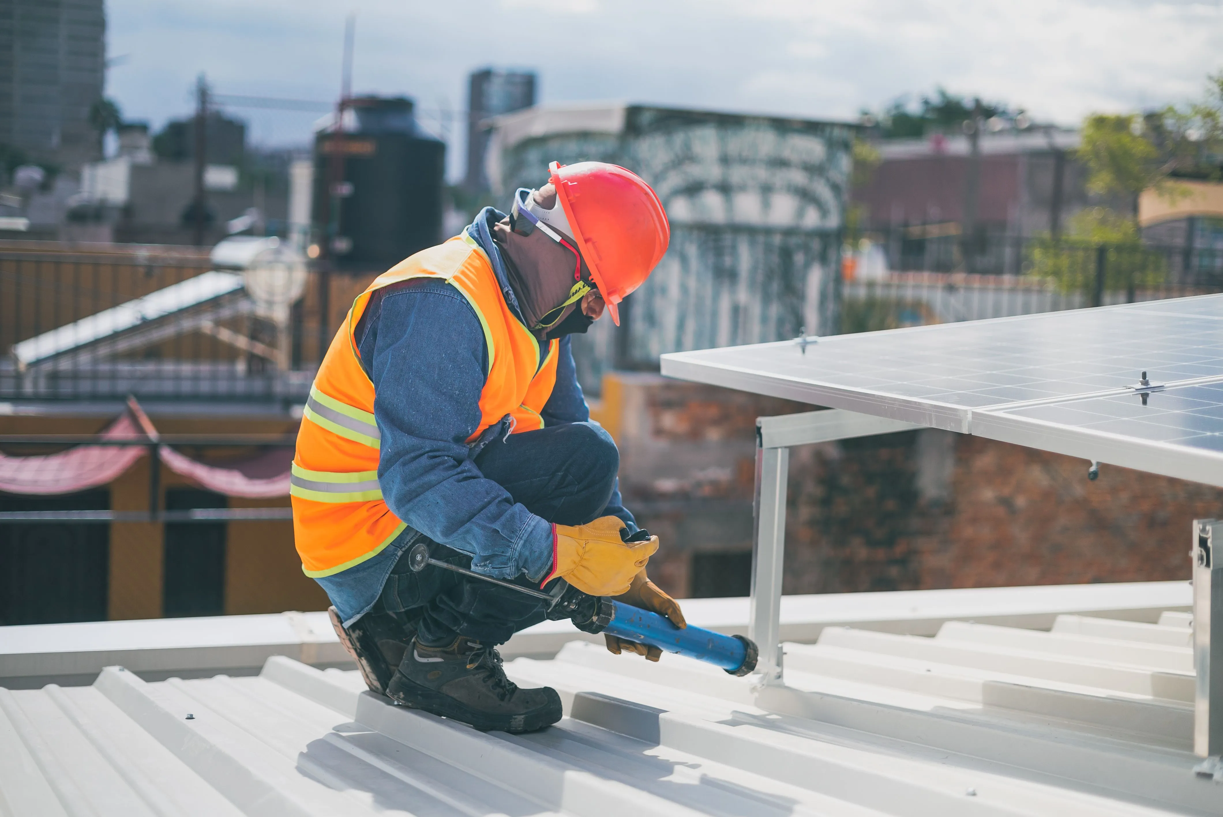 Solar installer inspecting and securing rooftop solar panel mounting equipment while troubleshooting or servicing a residential solar system. The image reflects hands-on diagnosis and maintenance work, making it a strong visual fit for a guide on identifying why a solar system appears offline and resolving common system or monitoring issues.