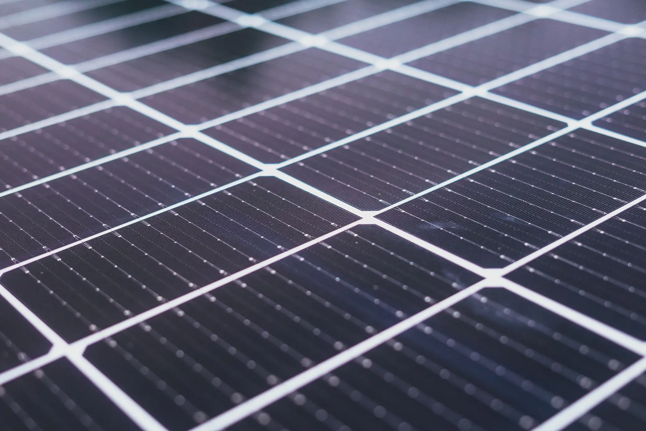 Close-up of photovoltaic solar panels, illustrating renewable energy technology used to generate electricity for UK homes.