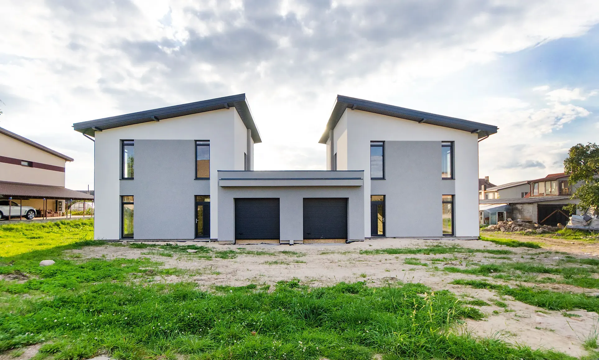 Modern newly built detached home with a clean roofline and attached double garage, illustrating an ideal property for integrating solar panels during or shortly after construction.